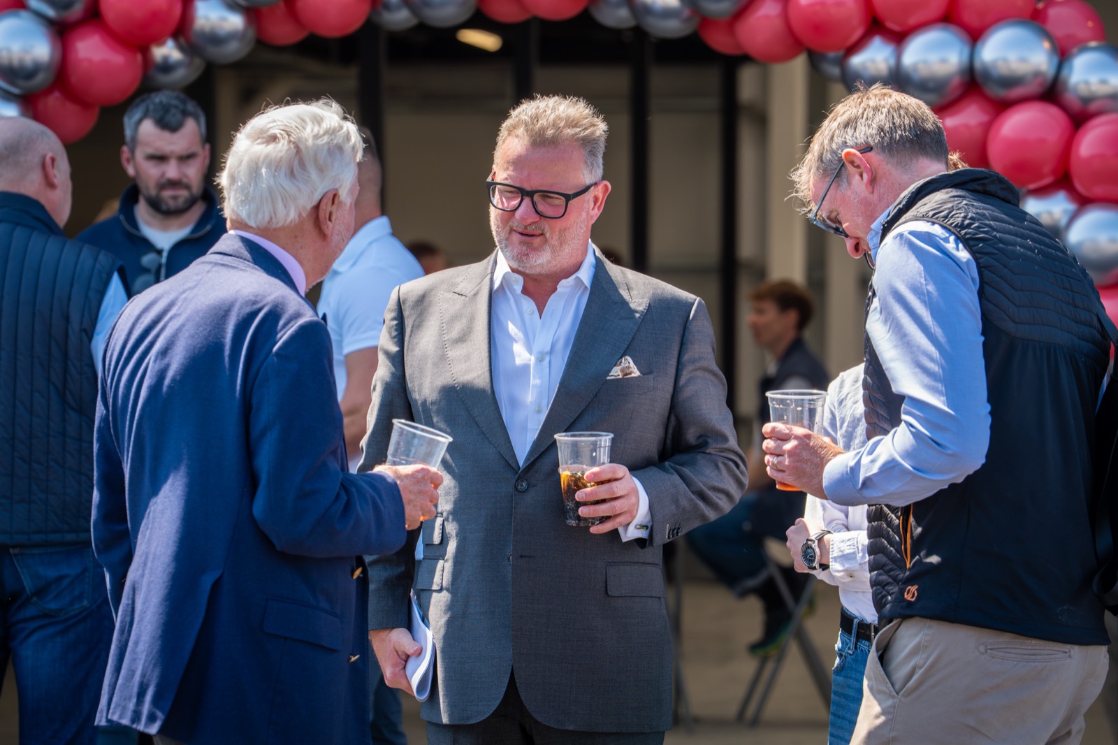 Yeats team and guests networking outside under the launch balloon arch